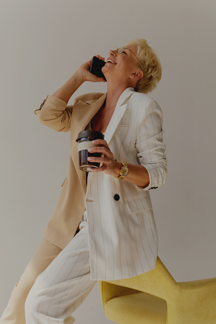 Woman in White and Beige Coat Talking on the Phone